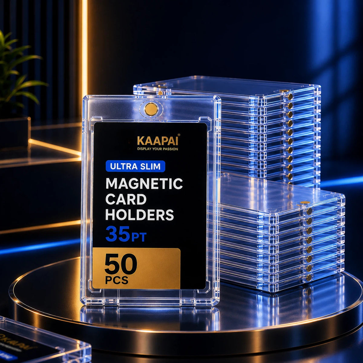 A clear acrylic magnetic card holder pack labeled KAAPAI, shown with one holder in front displaying a black insert and text reading 'ULTRA SLIM MAGNETIC CARD HOLDERS 35PT 50 PCS,' with multiple stacked holders in the background on a dark illuminated display surface.
