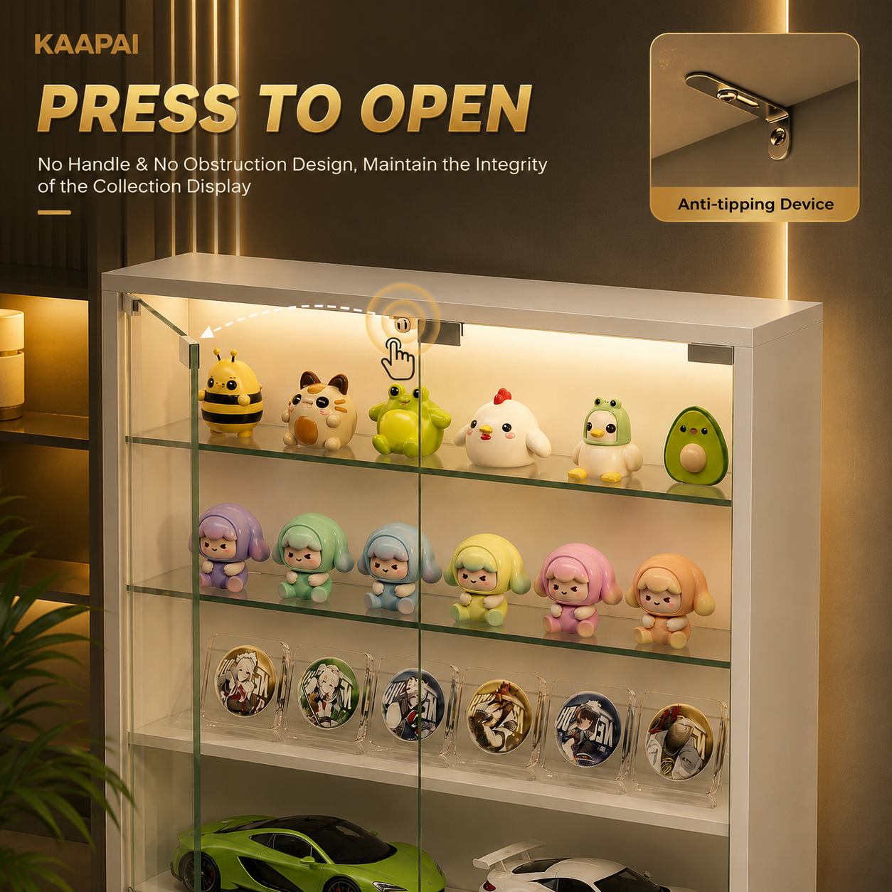 A white KAAPAI glass display cabinet with built-in LED lighting, shown holding collectible figurines, round badges, and small cars. Large promotional text reads 'PRESS TO OPEN' with an inset showing the anti-tipping device on the cabinet frame.
